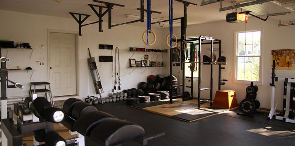 Another fully loaded and completely committed garage gym. Strongman gear in here even