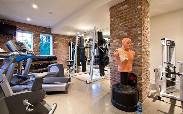Nice home gym studio with machines, rack and punching bag