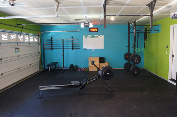 Fully committed garage gym - All the essentials - bars, rack, rower, bumper plates