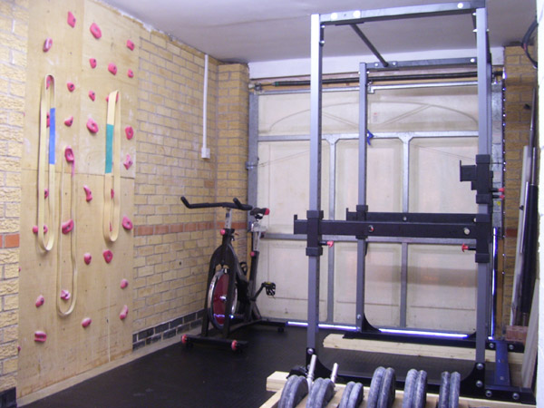 A garage gym with a rock climbing wall