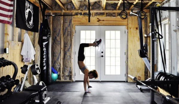 Doing handstands in the custom studio gym - Inspirational garage gyms 