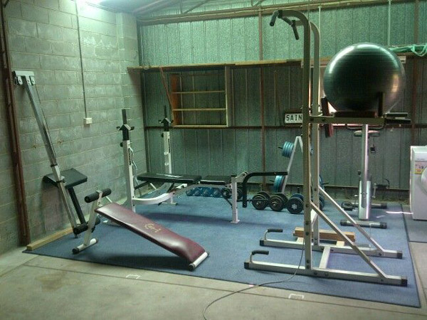 very cool compact garage gym with a classic cinder block feel