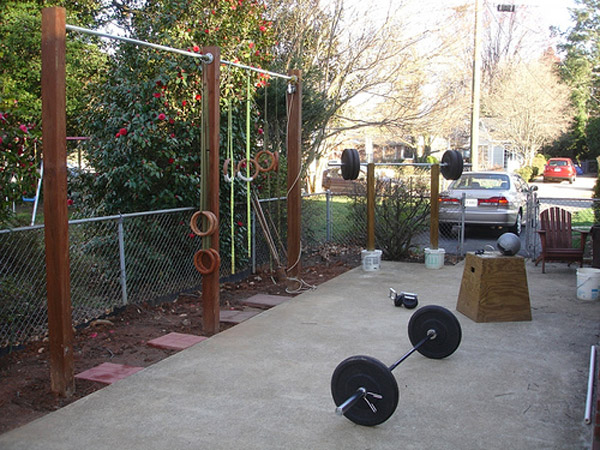Outdoor gym, probably a back yard gym. Lots of DIY. Very well done pull-up rig and squat stand. Get your workout done at home on the cheap