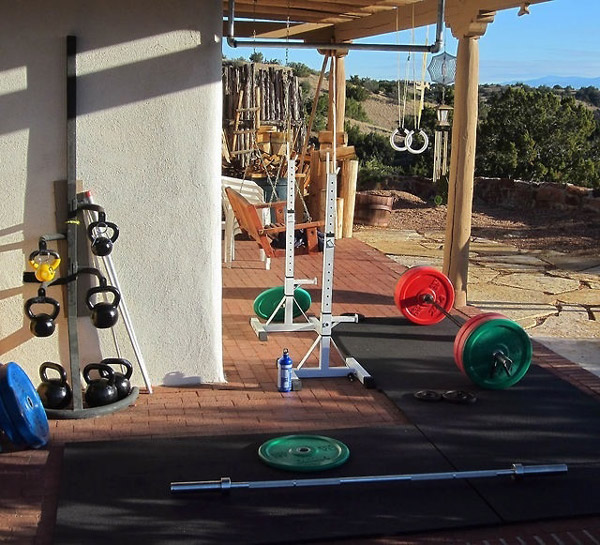 Killer back yard gym - colored bumper plates, kettlebells with nice rack, rings and squat stands