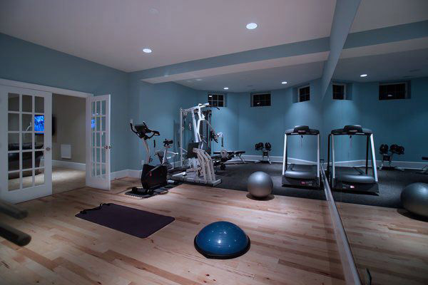 Nice den conversion into a home gym with weight gear, cardio, and core training