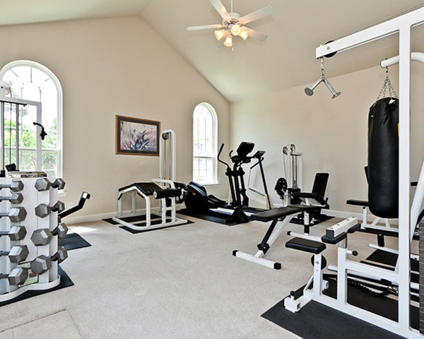 very well equipped home gym with all black on white gear