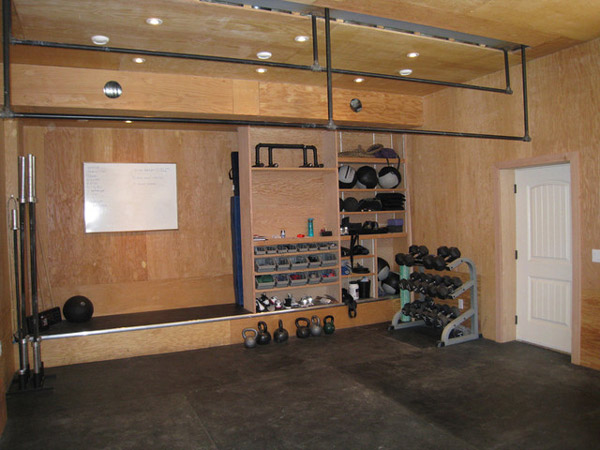 Unfinished traditional garage gym - very organized. where's the power rack