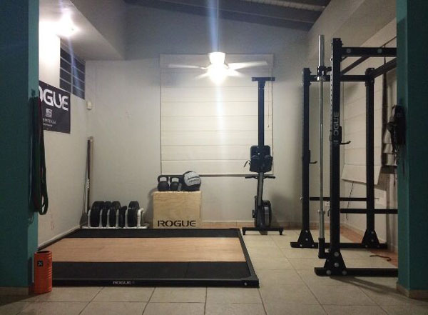 Rogue'd out garage gym - deadlift platform, R3 power rack, bumpers and probably even the bar. #ryourogue #garagegym