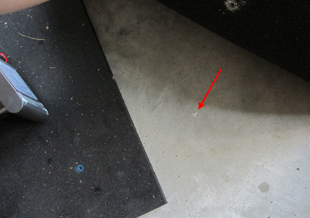 The mark on the concrete where I should continue drilling. Make sure not to drill at an angle