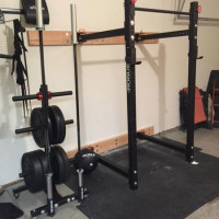 Rogue-equipped garage gym with folding power rack