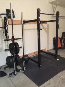 Rogue-equipped garage gym with folding power rack