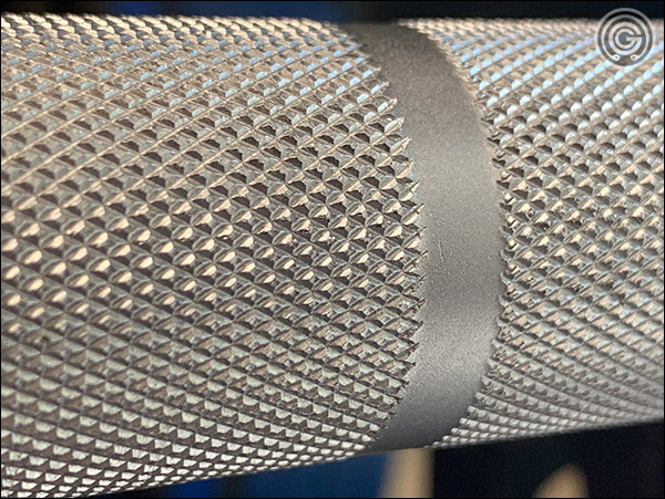 Close up of the Fringe Sport Hybrid Barbell outer knurling