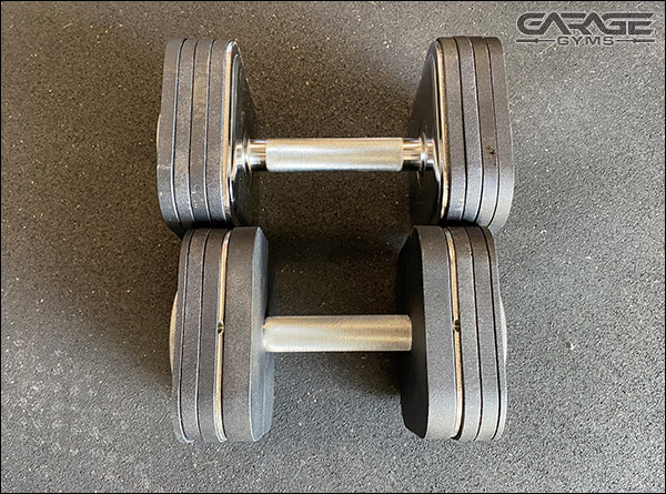 Both of these weigh 50-lbs, but the dumbbell with the Heavy Handle Kit is more compact